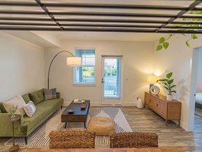Santee apartment for rent - A living room with a green couch, a coffee table, and a rug.