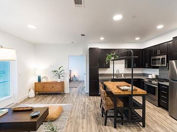 Santee apartment for rent - A modern kitchen with a dining table and chairs in the foreground.