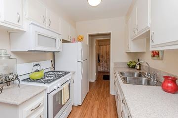 Ventura apartment for rent - A kitchen with white cabinets and a white refrigerator.