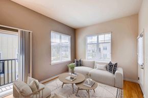 Boulder apartment for rent - A living room with a white couch, a coffee table, and windows.