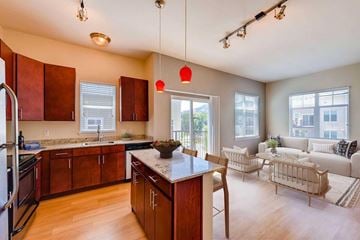 Boulder apartment for rent - A kitchen with wooden cabinets and a black countertop.