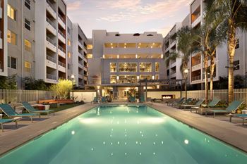 Resort-style pool featuring a sundeck and outdoor lounge