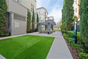 Anaheim apartment for rent - A grassy area in the community with the outdoor fireplace area in the background.