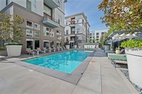 Anaheim apartment for rent - The community swimming pool with lounge chairs surronding.