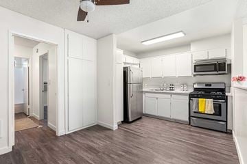 Sherman Oaks apartment for rent - A kitchen with white cabinets and a black refrigerator.