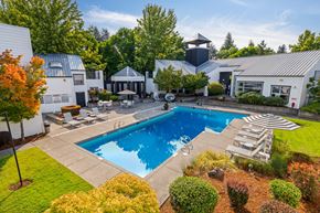 Beaverton apartment for rent - Pool and spa with view of clubhouse and trees in background.