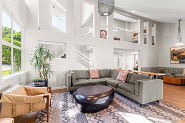 Beaverton apartment for rent - A living room with a grey couch and a brown chair.