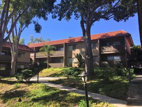 Vista apartment for rent - a row of apartment buildings with sidewalks and trees in front of them
