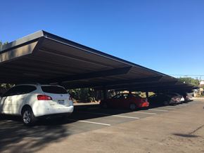 Vista apartment for rent - awning over a parking lot with cars parked under it