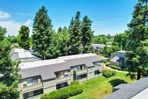 Modesto apartment for rent - Aerial view of the community with lawns, landscaping, and balconies and patios.
