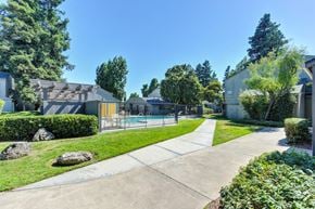 Modesto apartment for rent - Poolside lawn and exterior walkway.