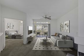 Las Vegas apartment for rent - Carpeted living room with view to bedroom and patio with sliding glass door.