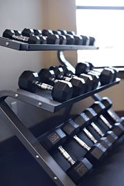 Denton apartment for rent - A set of dumbbells on a rack in a gym.