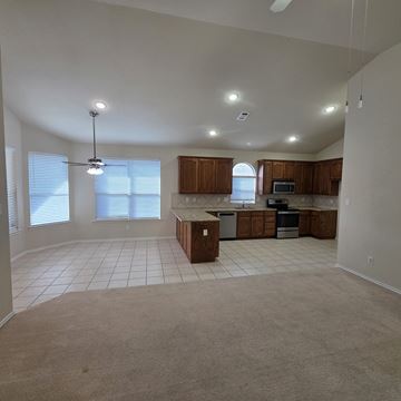 Sanger apartment for rent - A kitchen with white cabinets and a countertop.
