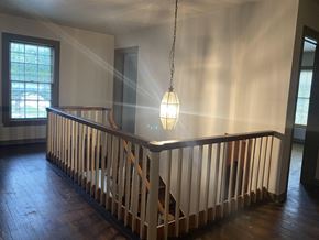 Denton apartment for rent - arial view of a landing with a wooden railing and a light fixture