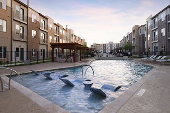 A pool with dolphins in the middle of an apartment building