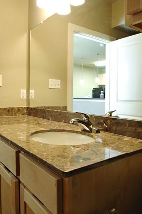 Denton apartment for rent - A bathroom with a sink and mirror at Centre Place Apartments, Denton