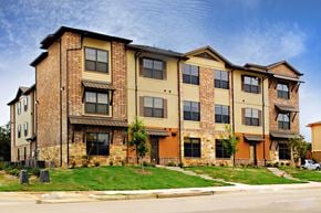 Denton apartment for rent - A large brick apartment building with multiple windows and balconies at Centre Place Apartments, Texas, 76205