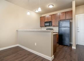 Denton apartment for rent - Kitchen with wood cabinets and breakfast bar at City Place Apartments, Texas, 76201