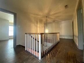 Denton apartment for rent - an empty living room with a railing and a light