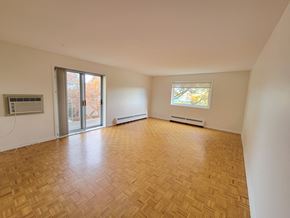 Kingston apartment for rent - A room with wooden flooring and a window with a view of trees.