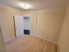 Kingston apartment for rent - A room with a white door and wooden flooring.