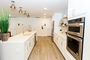 Coral Springs apartment for rent - a large kitchen with white cabinets and stainless steel appliances