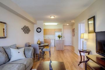 Kingston apartment for rent - A living room with a grey couch and a wooden floor.