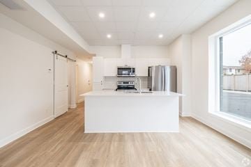 Kingston apartment for rent - A kitchen with a white counter and wooden flooring.