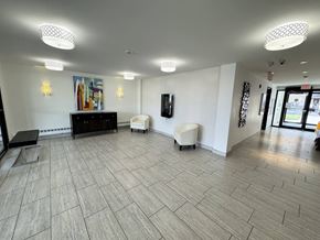 Kingston apartment for rent - A spacious room with a wooden floor and white walls.
