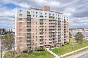 Kingston apartment for rent - A large apartment building with a grassy area in front.