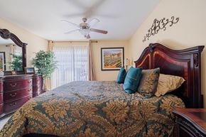 Houston apartment for rent - A bedroom with a large bed and a ceiling fan.