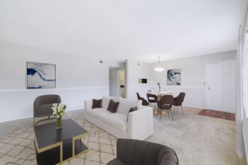 Houston apartment for rent - A living room with a white couch and a coffee table.