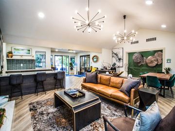 Killeen apartment for rent - A modern living room with a brown leather couch and a black coffee table.