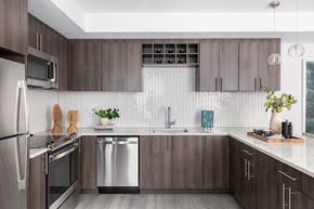 Washington apartment for rent - A modern kitchen with dark wood cabinets and stainless steel appliances.