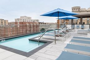 Washington apartment for rent - A blue umbrella shades a pool area.
