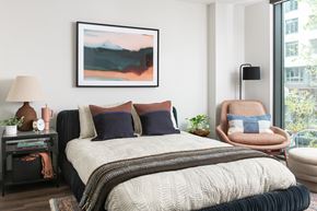 Washington apartment for rent - A bedroom with a large bed and a painting on the wall.