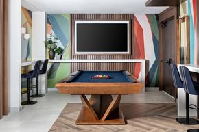 Washington apartment for rent - A pool table with a television above it in a room.