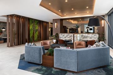 Washington apartment for rent - A modern living room with a grey sofa and a wooden floor.