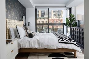 Washington apartment for rent - A bedroom with a large bed and a view of the city.