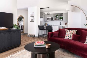Washington apartment for rent - A living room with a red couch and a black coffee table.