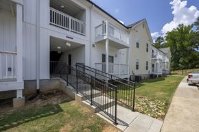 Columbia apartment for rent - A white building with a black gate in front at Peachtree Place Apartments, Columbia, South Carolina