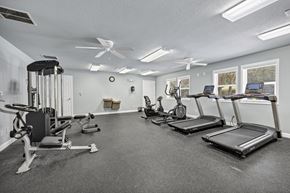 Columbia apartment for rent - A spacious gym with treadmills, elliptical machines, and a weight bench. at Peachtree Place Apartments, Columbia 29210