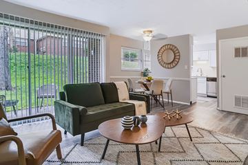 Lexington apartment for rent - A living room with a green couch and a wooden coffee table.