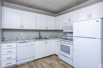 Jonesboro apartment for rent - A kitchen with white cabinets and appliances.