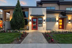 Meridian townhouse for rent - A modern house with a red door and a well-maintained garden. at Verraso Village Apartments, Meridian, ID