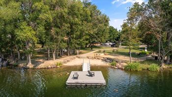 Lakefront dock with swimming area and beach