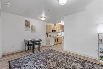 Garden City apartment for rent - A kitchen with a table and chairs in the middle of the room.