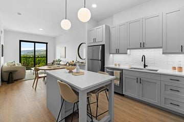 Bozeman apartment for rent - A modern kitchen with a dining table and chairs.