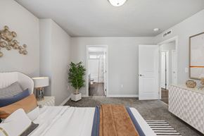 Nampa apartment for rent - a bedroom with a large bed and a door to a hallway